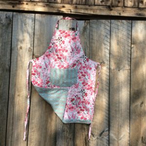 adult apron, red & pink flowers, geometric print pocket and reverse