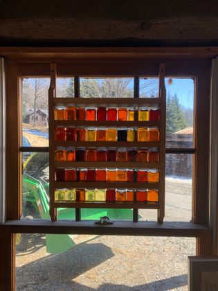 Window with bottles of maple syrup