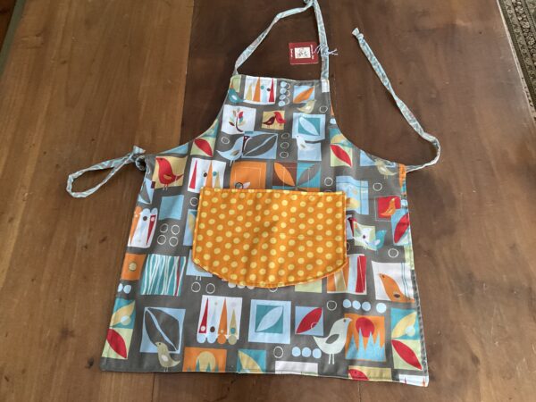 Child's apron brown with birds, orange polkadot pocket