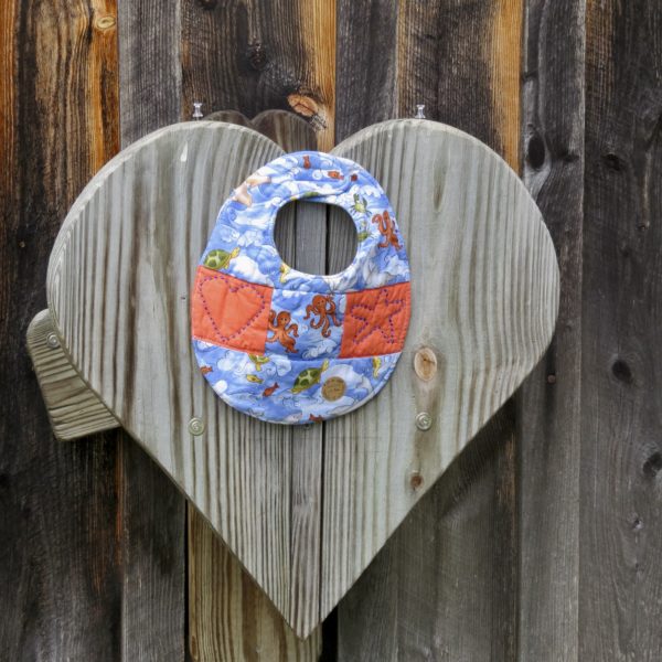 quilted baby bib, blue with orange underwater creatures, quilt star and heart