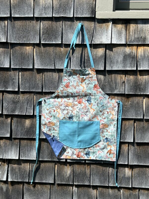 Multi color butterflies on blue background with aqua pocket