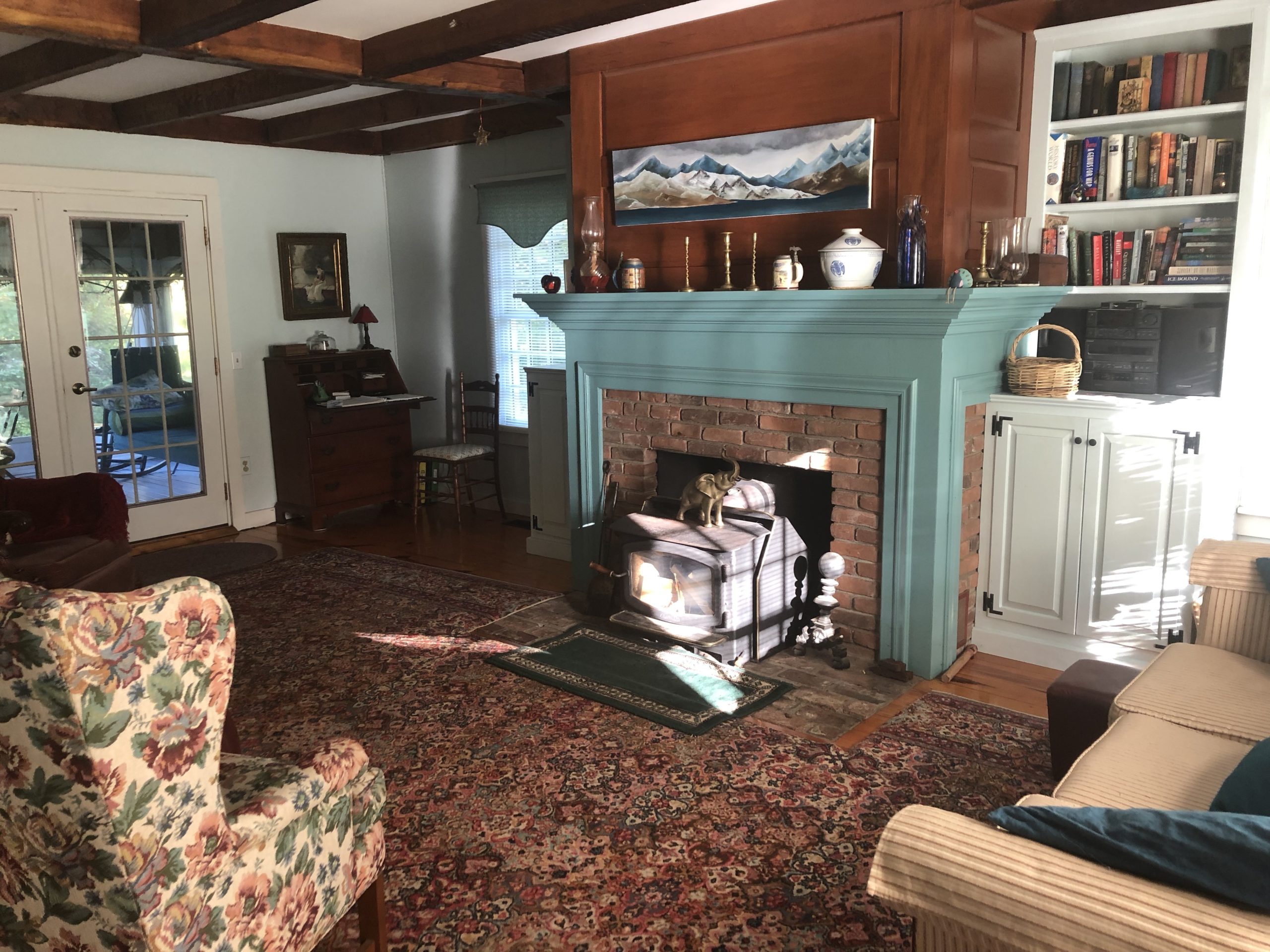 living room, fireplace, bookcases, desk, chair