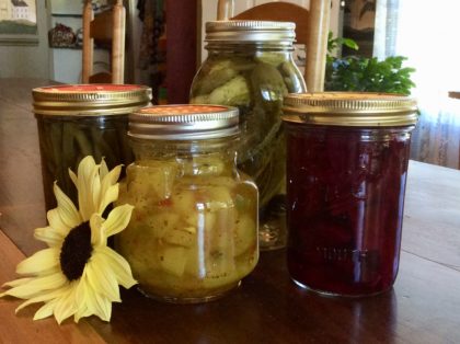 4 jars of preserved pickles, yellow sunflower